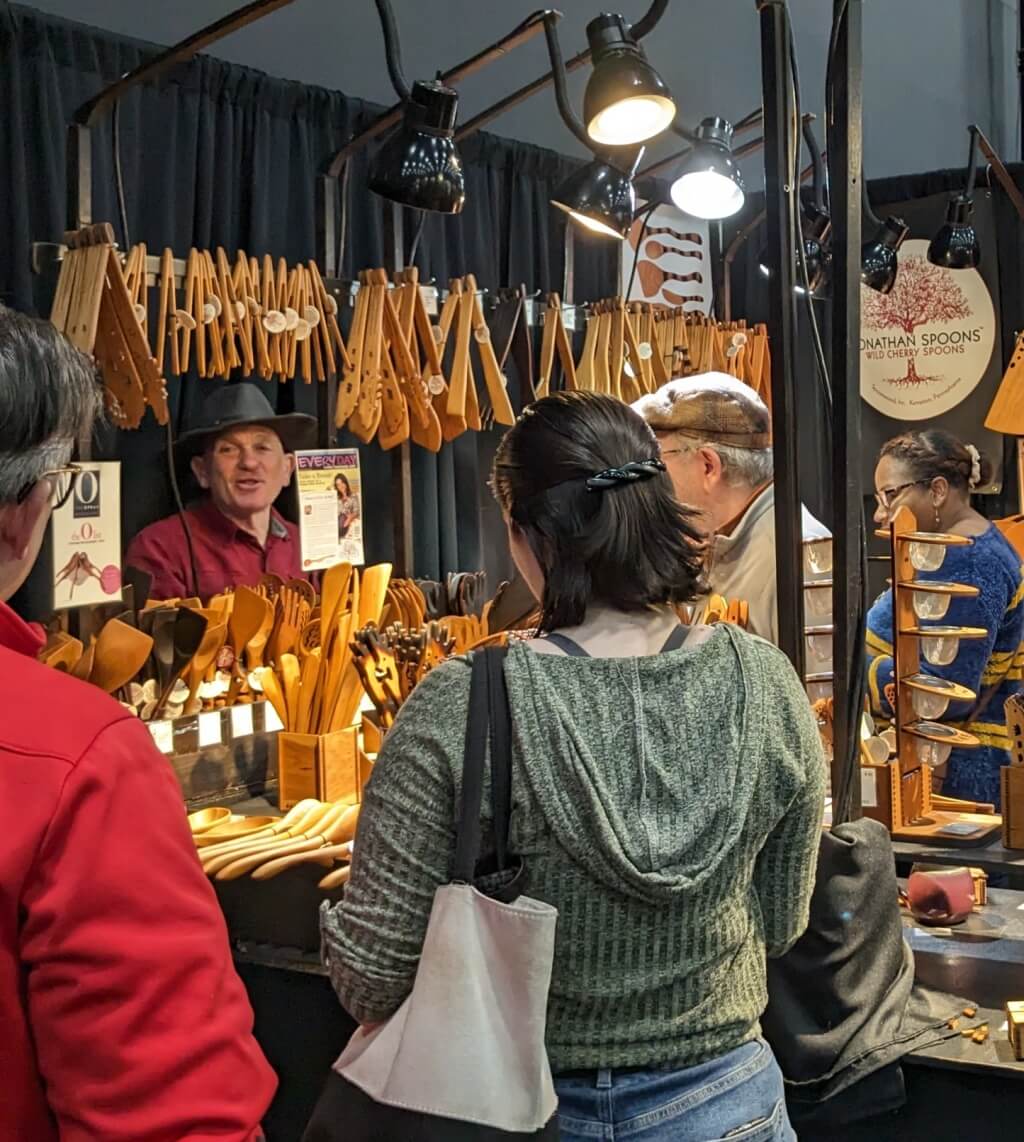 Vendor selling items at festival, Image by https://www.freepik.com/free-photo/person-barter-event-exchanging-goods_38673409